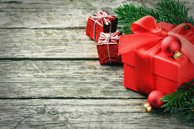 Photo of a red Christmas present surrounded by Christmas decorations