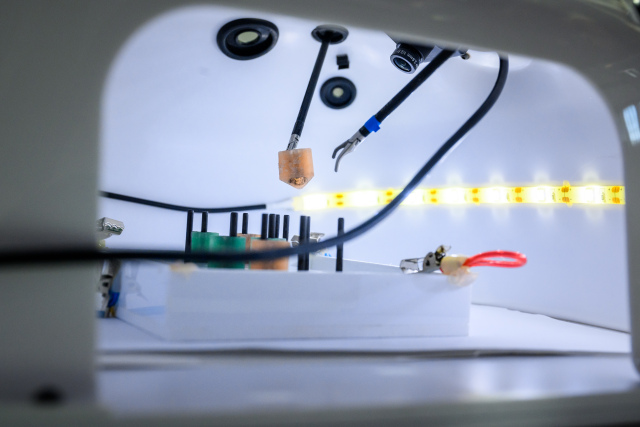 The image shows a robot-assisted endoscope control system from the inside and demonstrates how a gripper works with precision.
